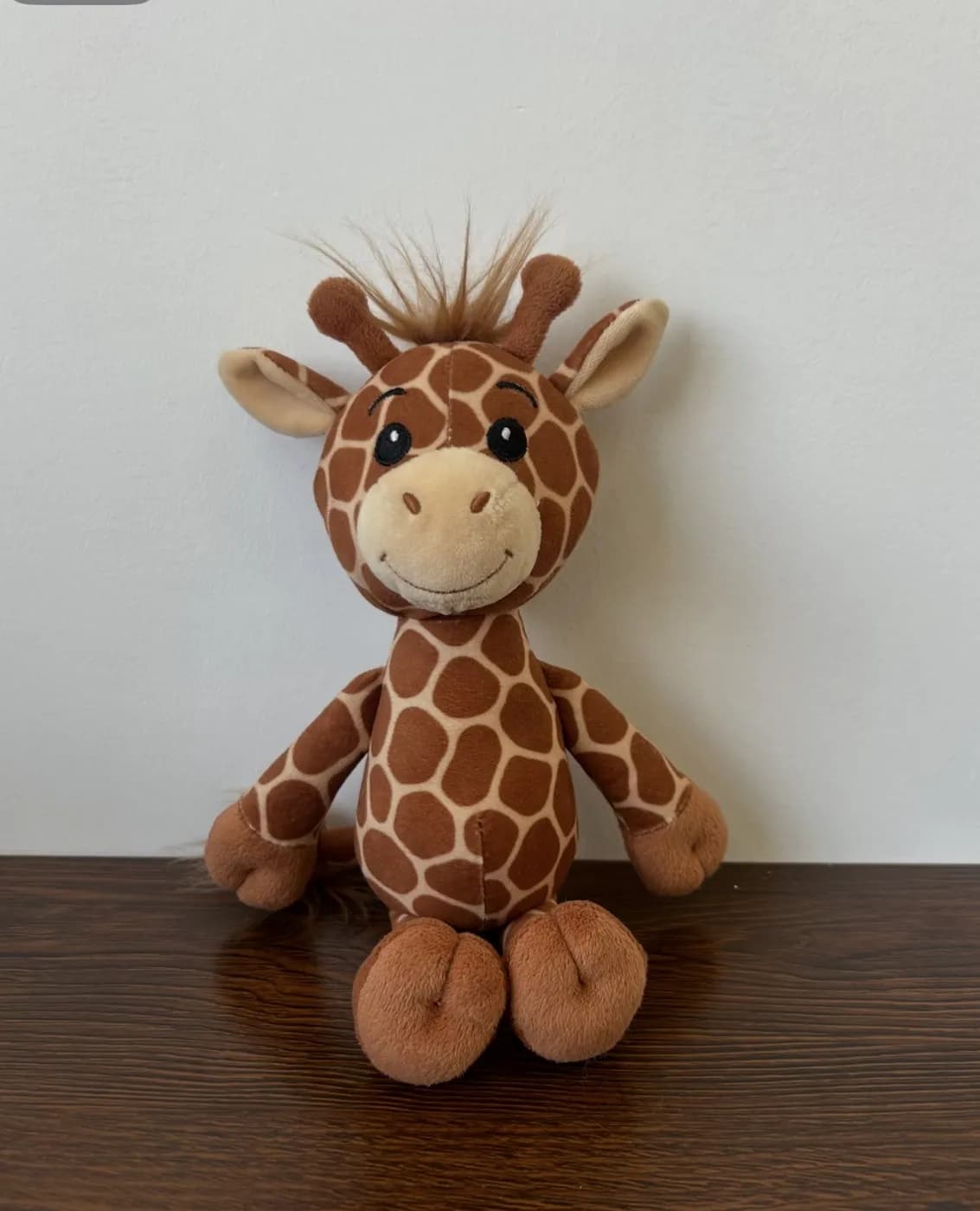 Giraffe stuffed animal with a printed spot pattern and tufted mane