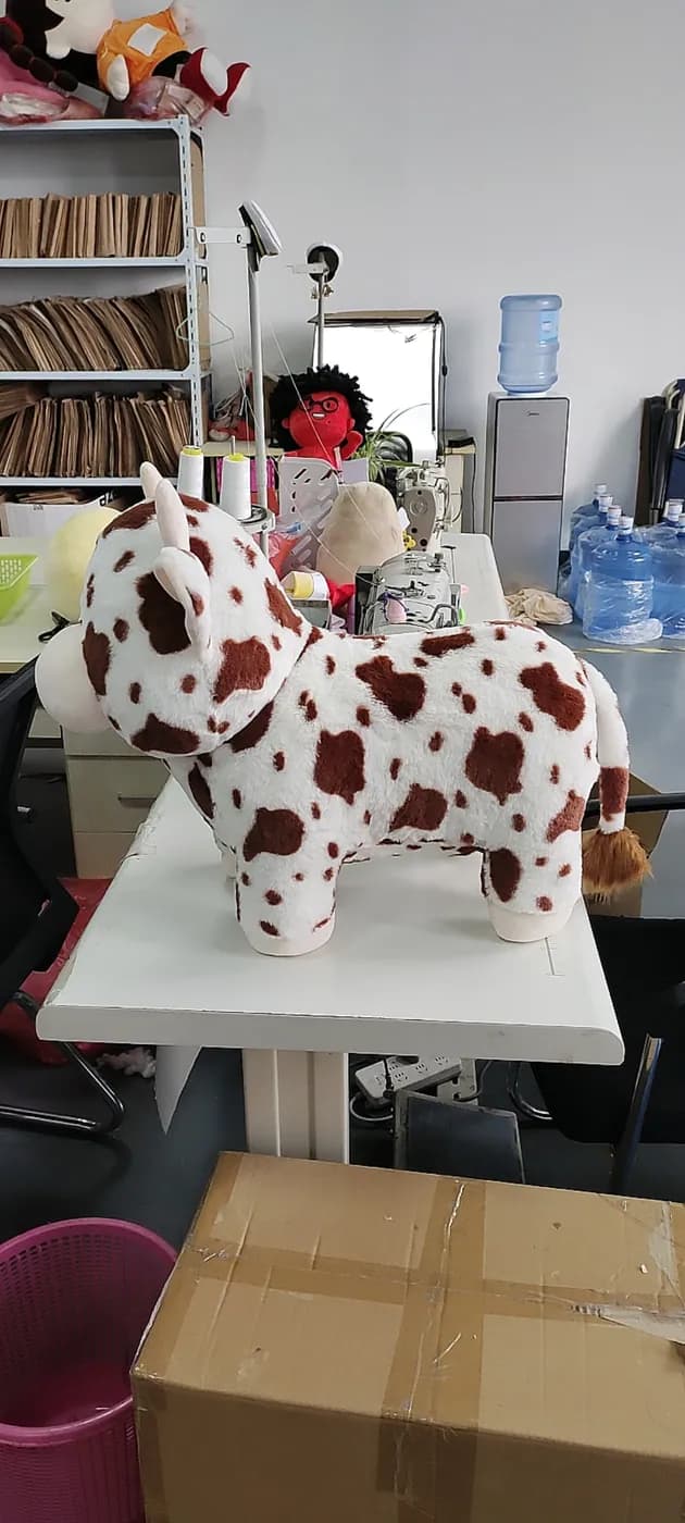 Printed pony plush toys arranged on the sample bench