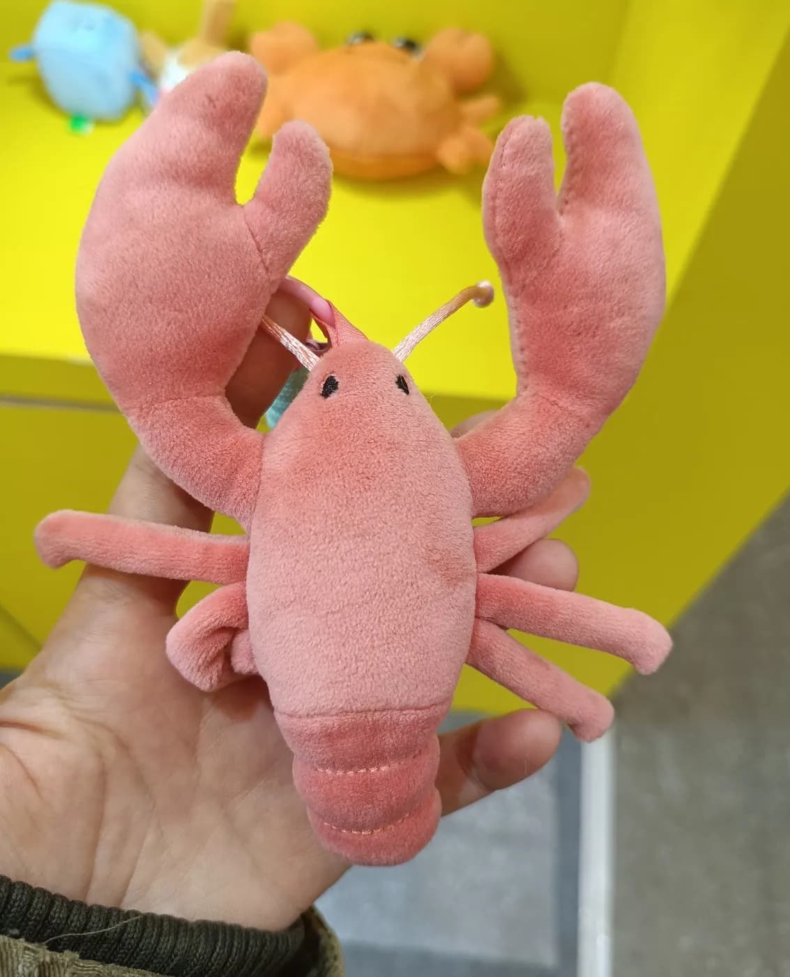 Pink lobster plush toy with wired antennae and jointed claws