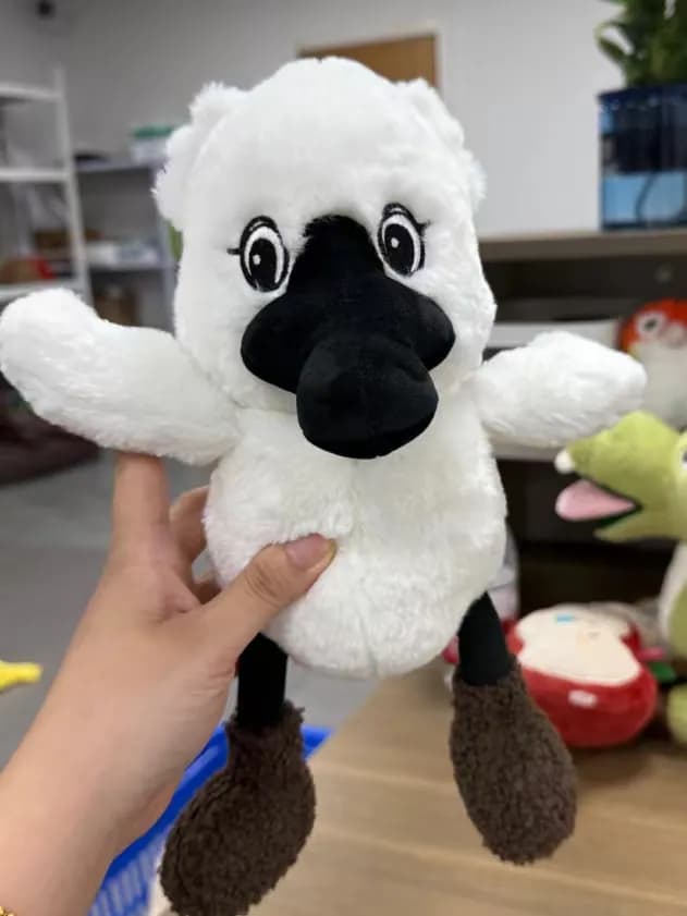 White long-pile animal plush with a moulded black beak