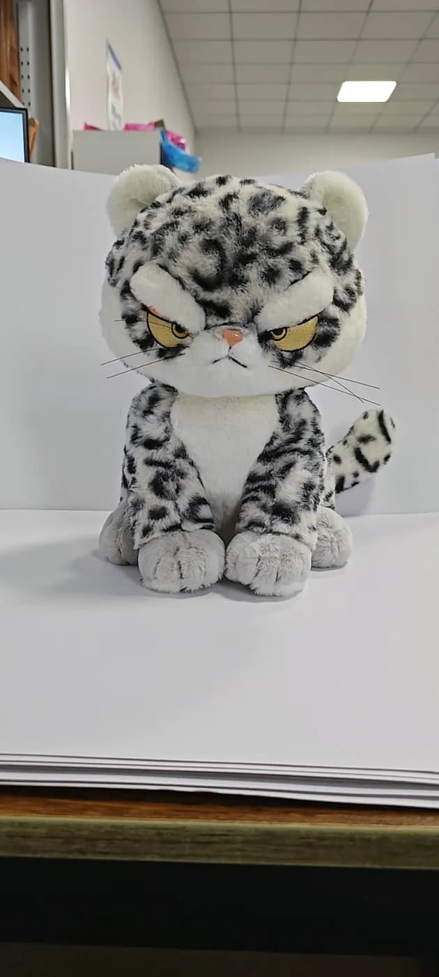 Custom snow leopard plush toy with printed rosettes on a plain sweep