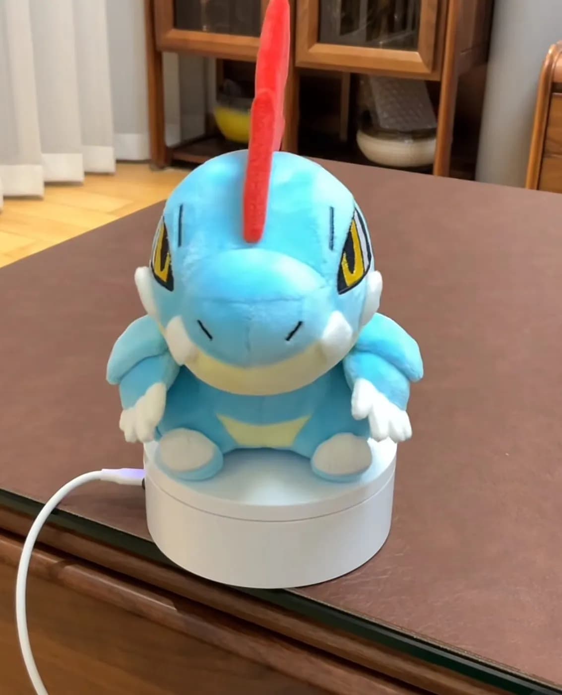 Blue crocodile game character plush with a red crest