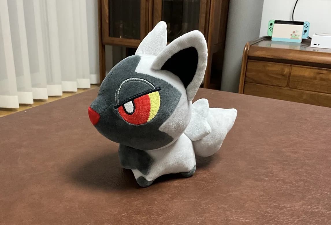 Black and white fox game character plush with printed markings