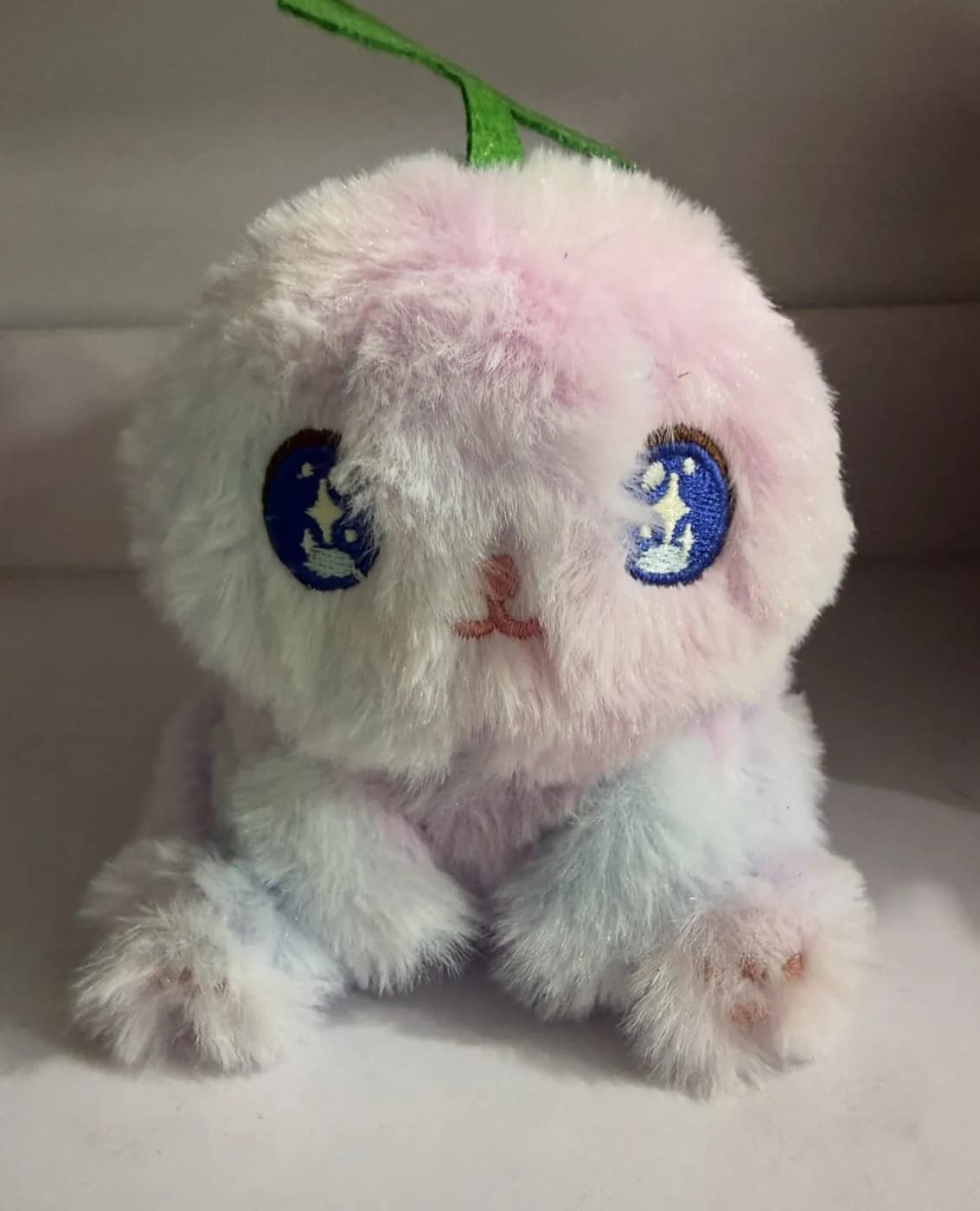 Pink long-pile character plush with large appliqué eyes