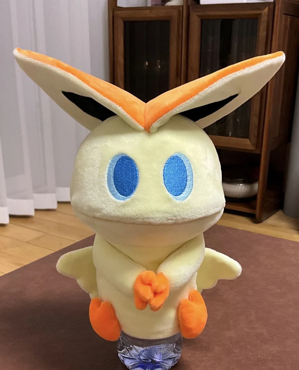 Yellow character plush with tall ears and appliqué eyes