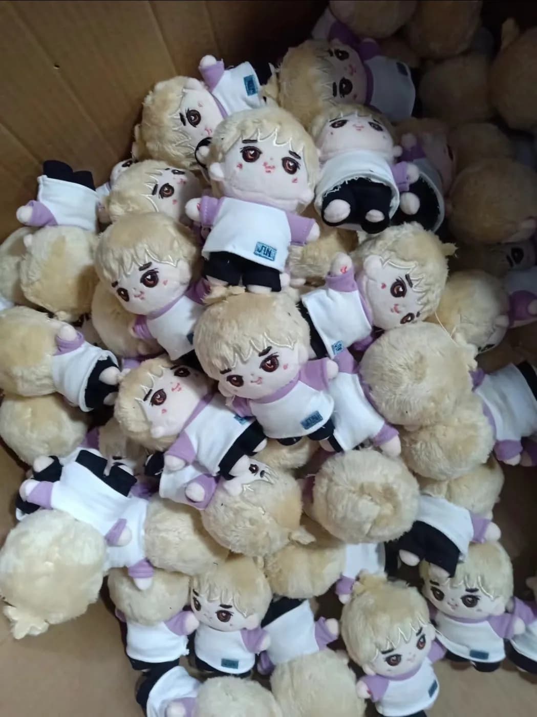 Finished cream plush toys with hangtags attached before packing