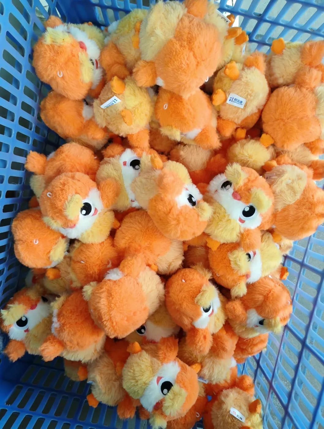 Production crate of orange plush charms after sewing