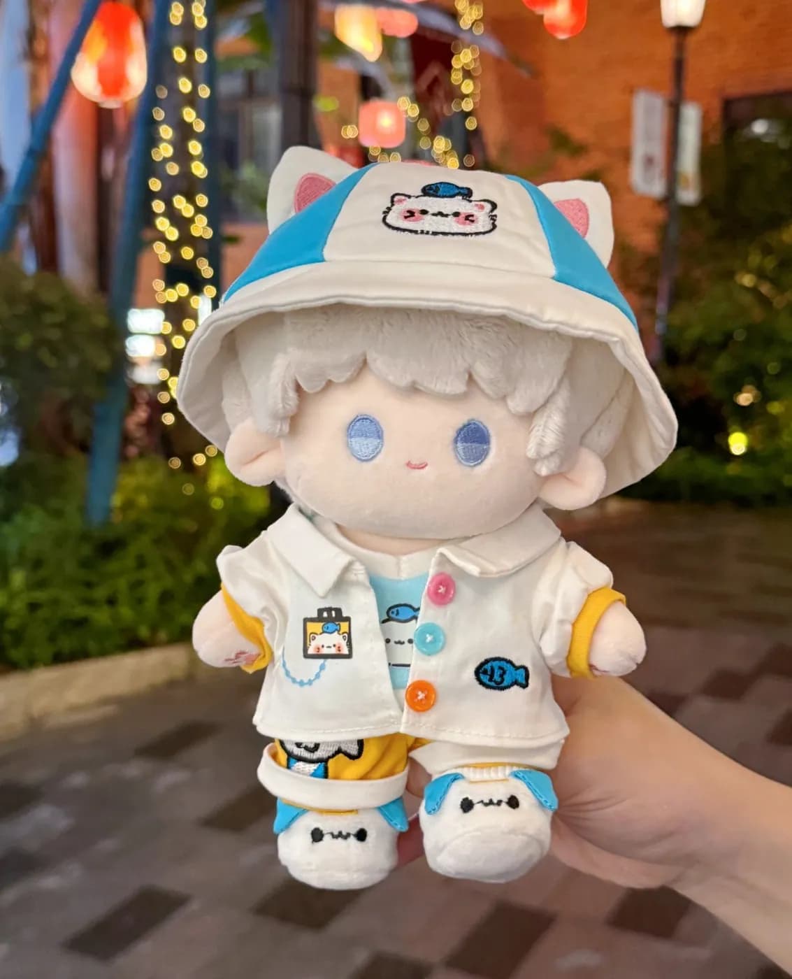 Cotton doll in a printed jacket and removable bucket hat