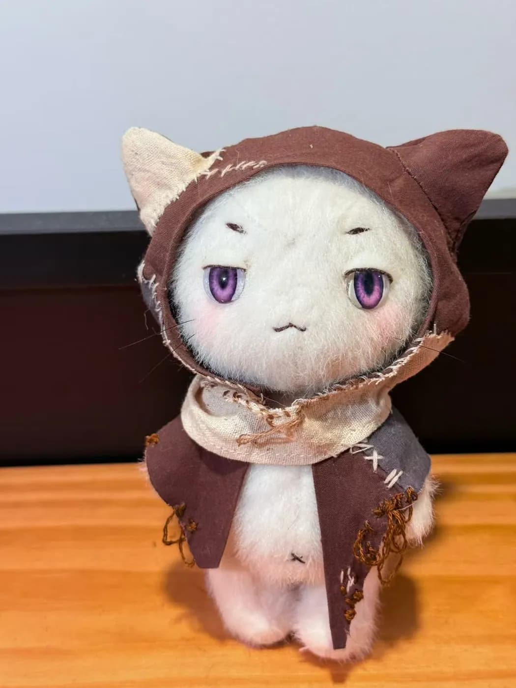 Custom cotton doll in a brown cat hood with hand-embroidered eyes