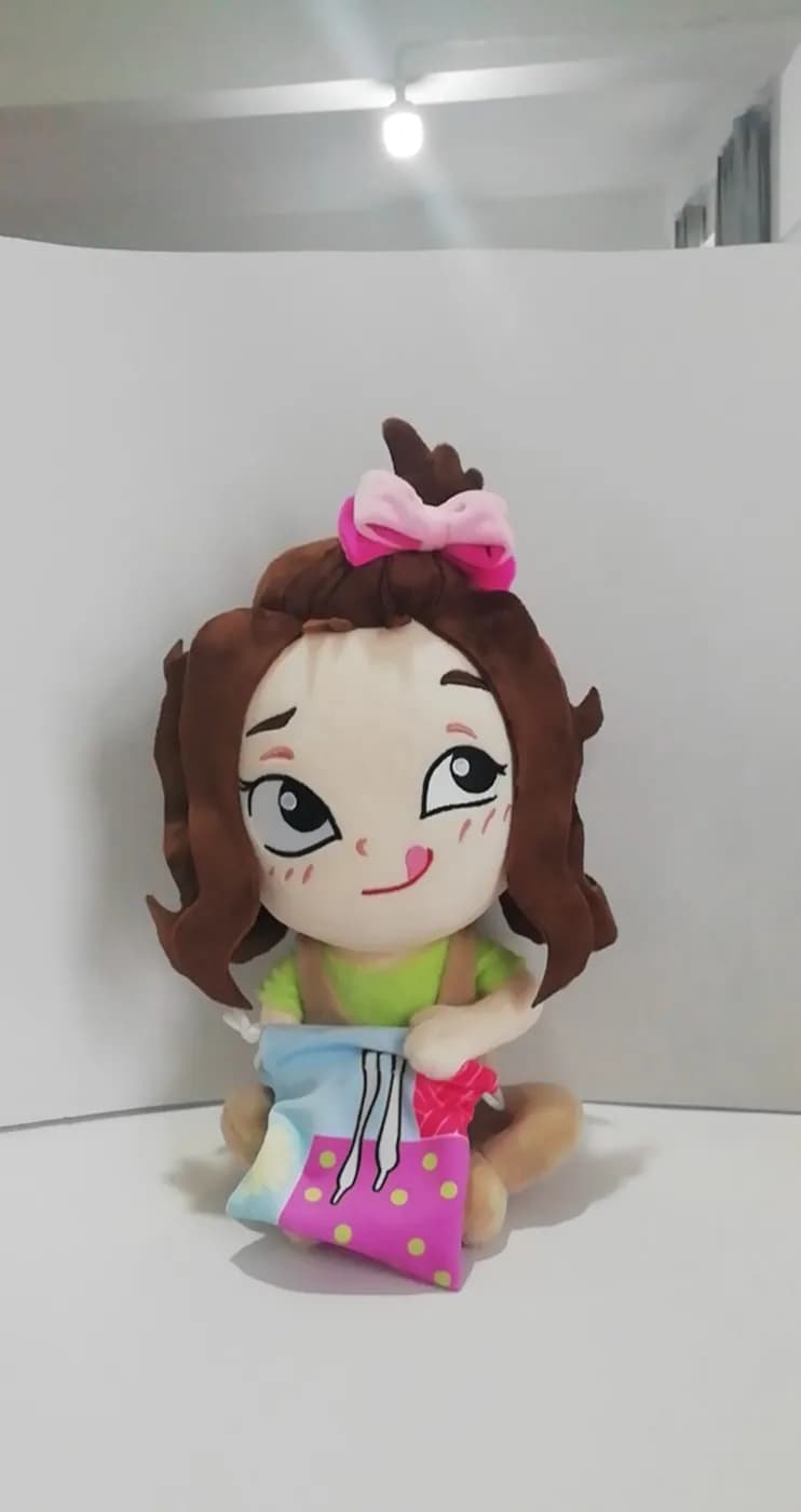 Character doll in a printed dress with curled hair