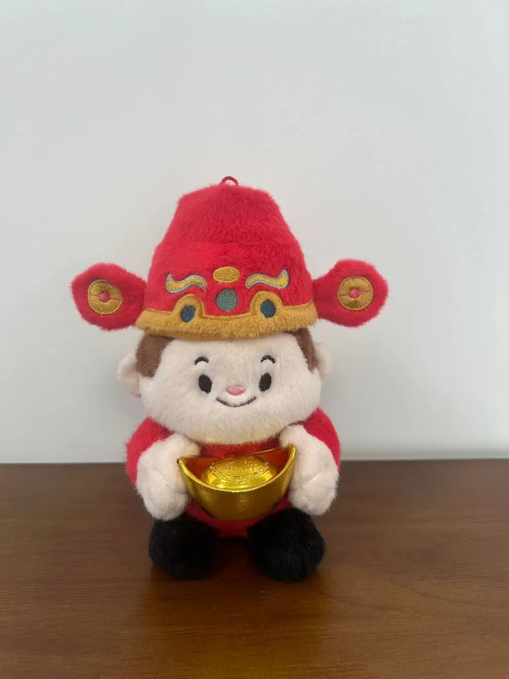 Fortune child character doll with a printed robe and gold ingot
