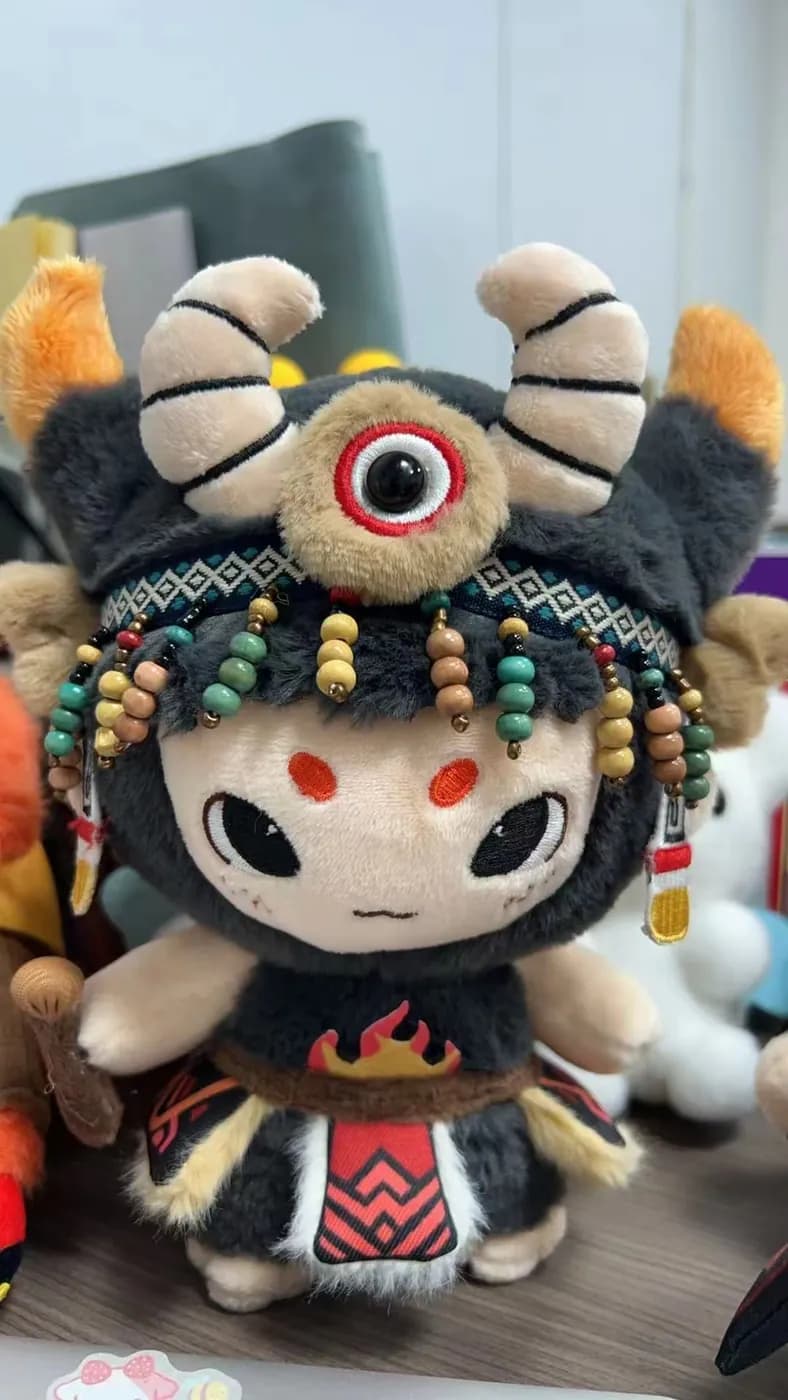 Opera character doll with a beaded headdress and printed costume