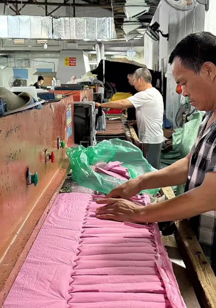 Cut fabric panels being sorted at the cutting table