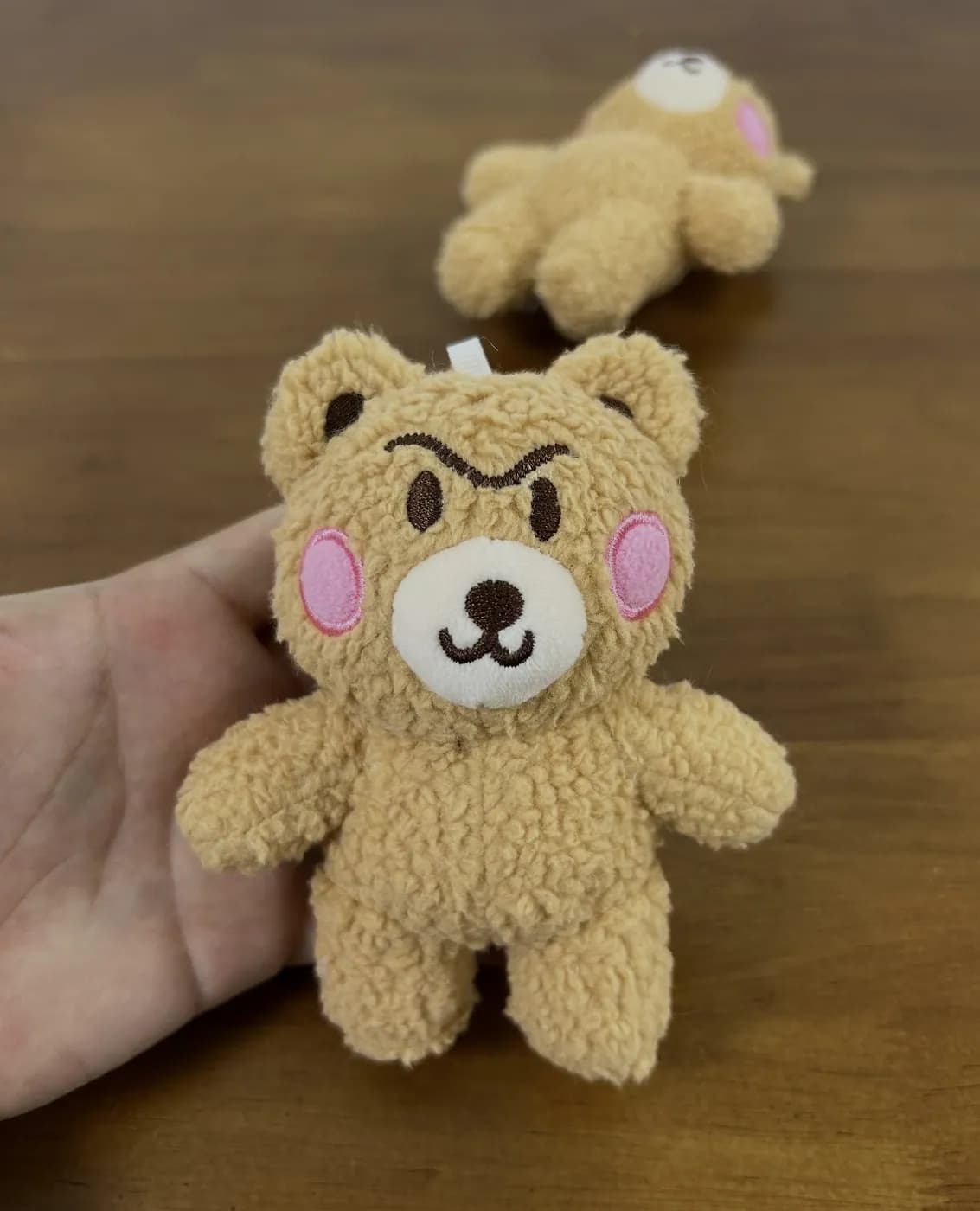 Beige bear plush charm with contrast embroidered brows