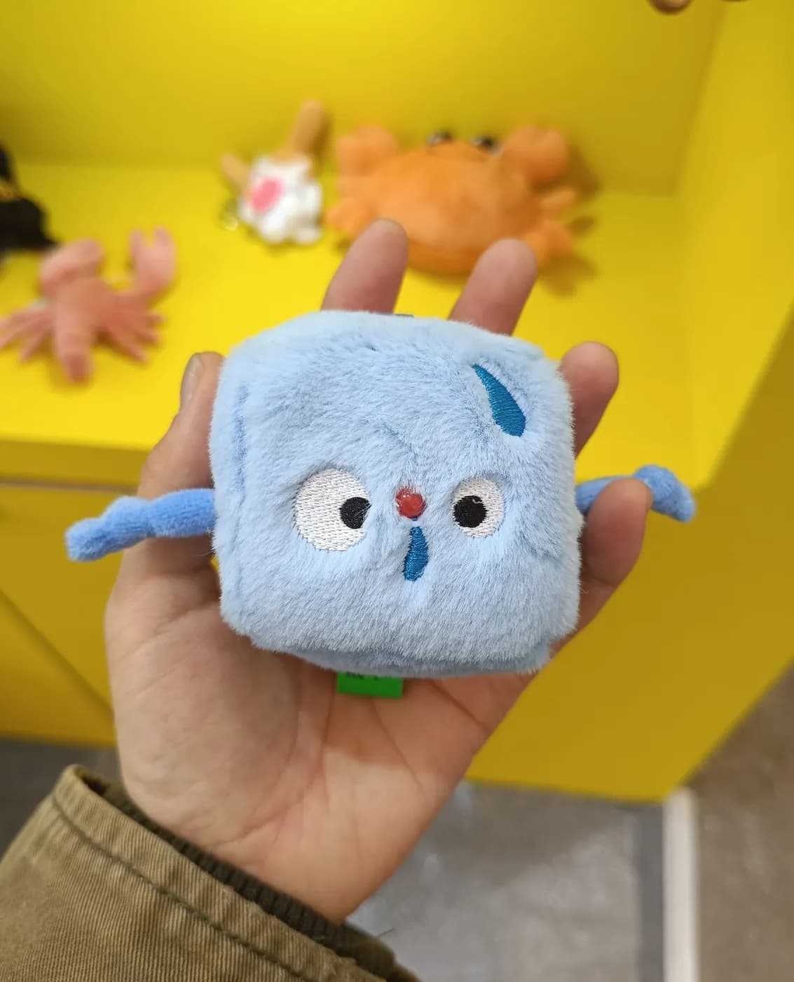 Square blue character plush charm with an embroidered face