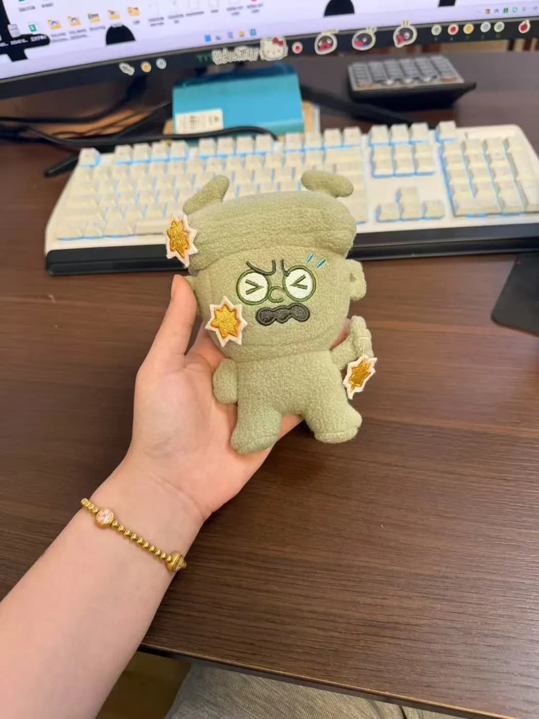 Beige monster plush charm with printed sticker patches