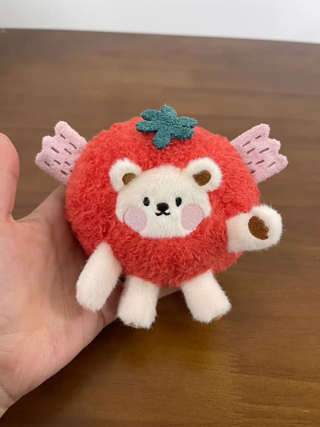 Strawberry bear plush charm in red curly fabric with felt wings