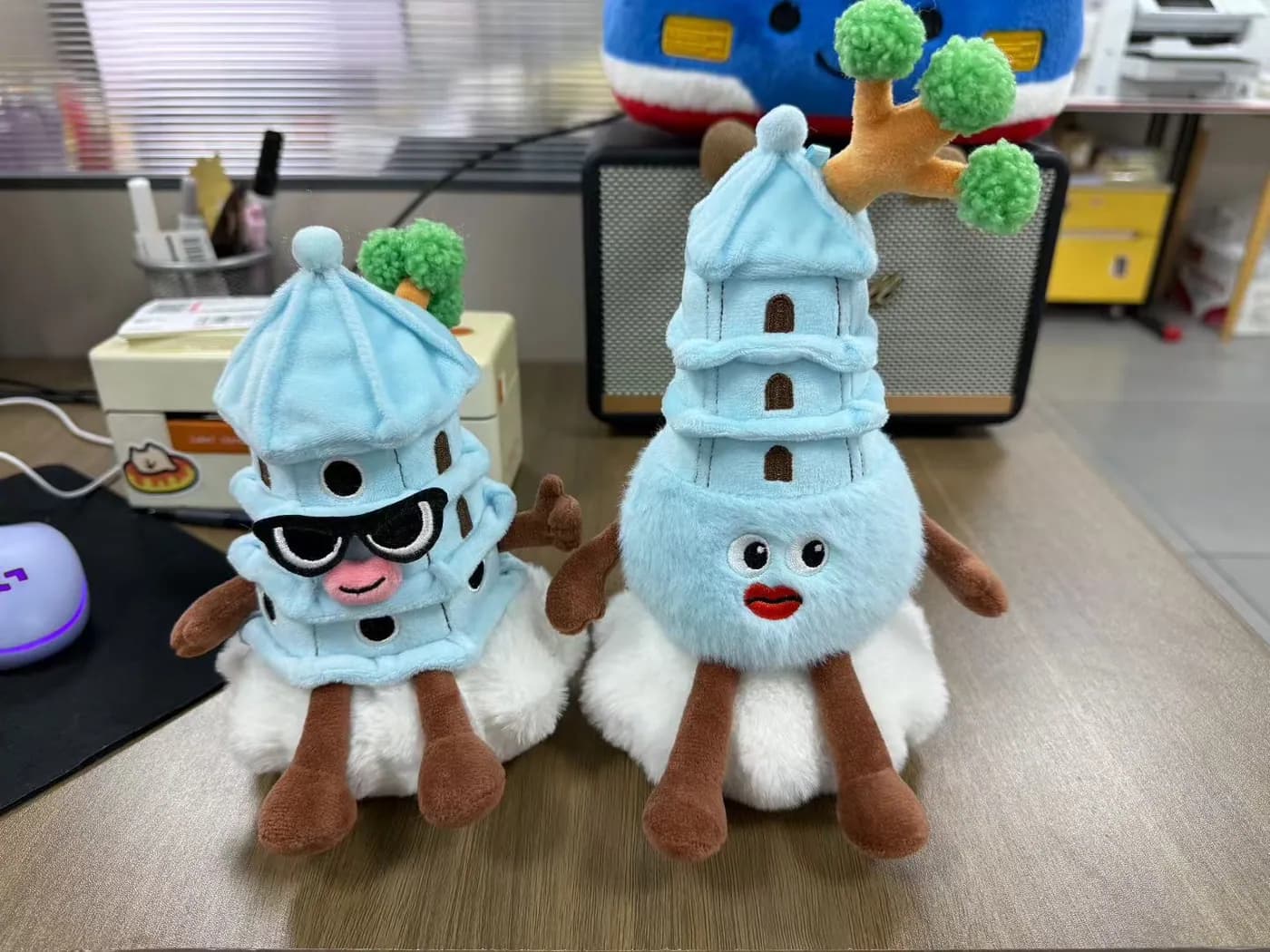 Pair of blue pagoda plush souvenirs with printed windows