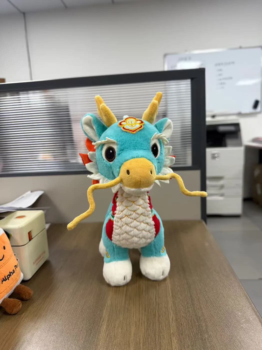 Teal dragon mascot plush with metallic scale fabric and gold whiskers