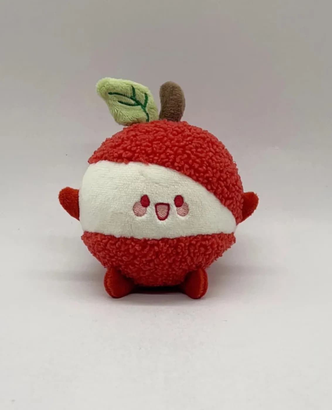 Apple character plush in curly boucle fabric with a fabric leaf