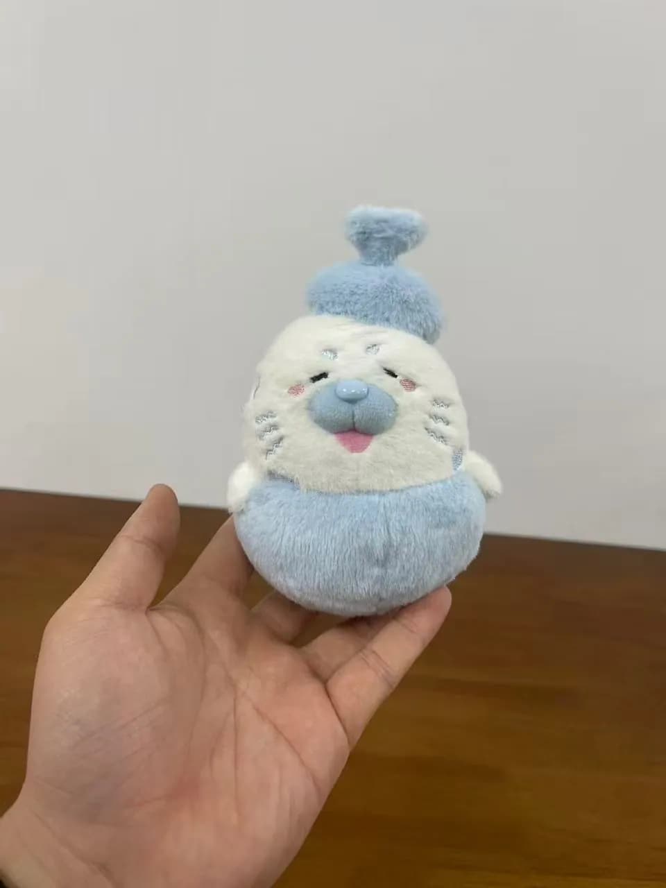 Pale blue steamed-bun character plush with an embroidered face