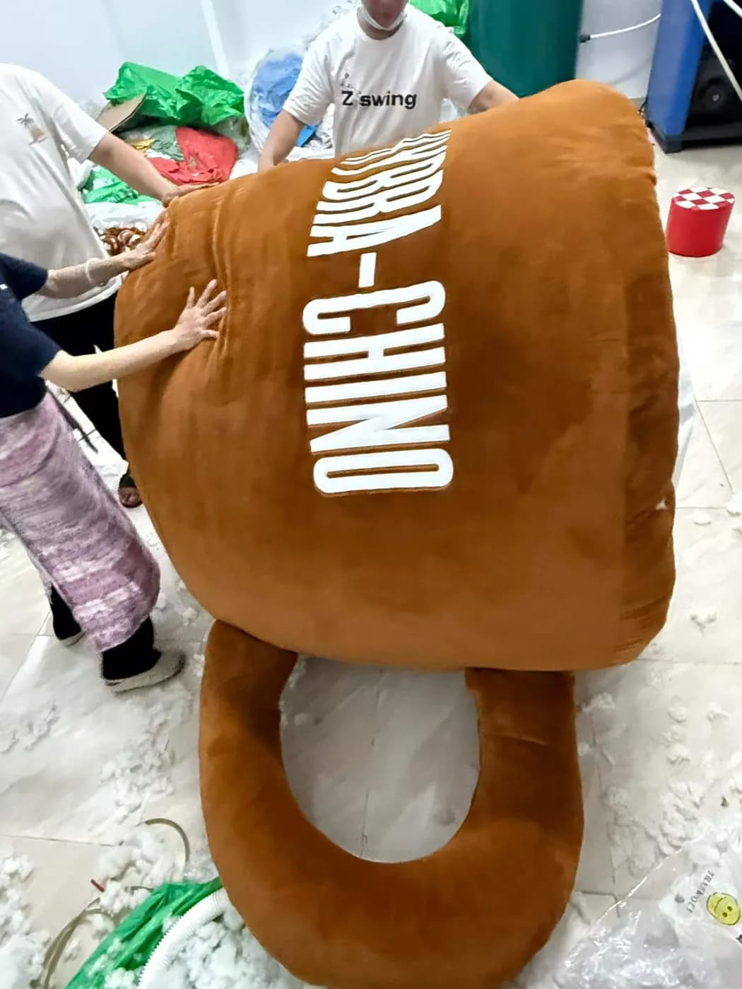 Oversized coffee cup plush cushion, side view