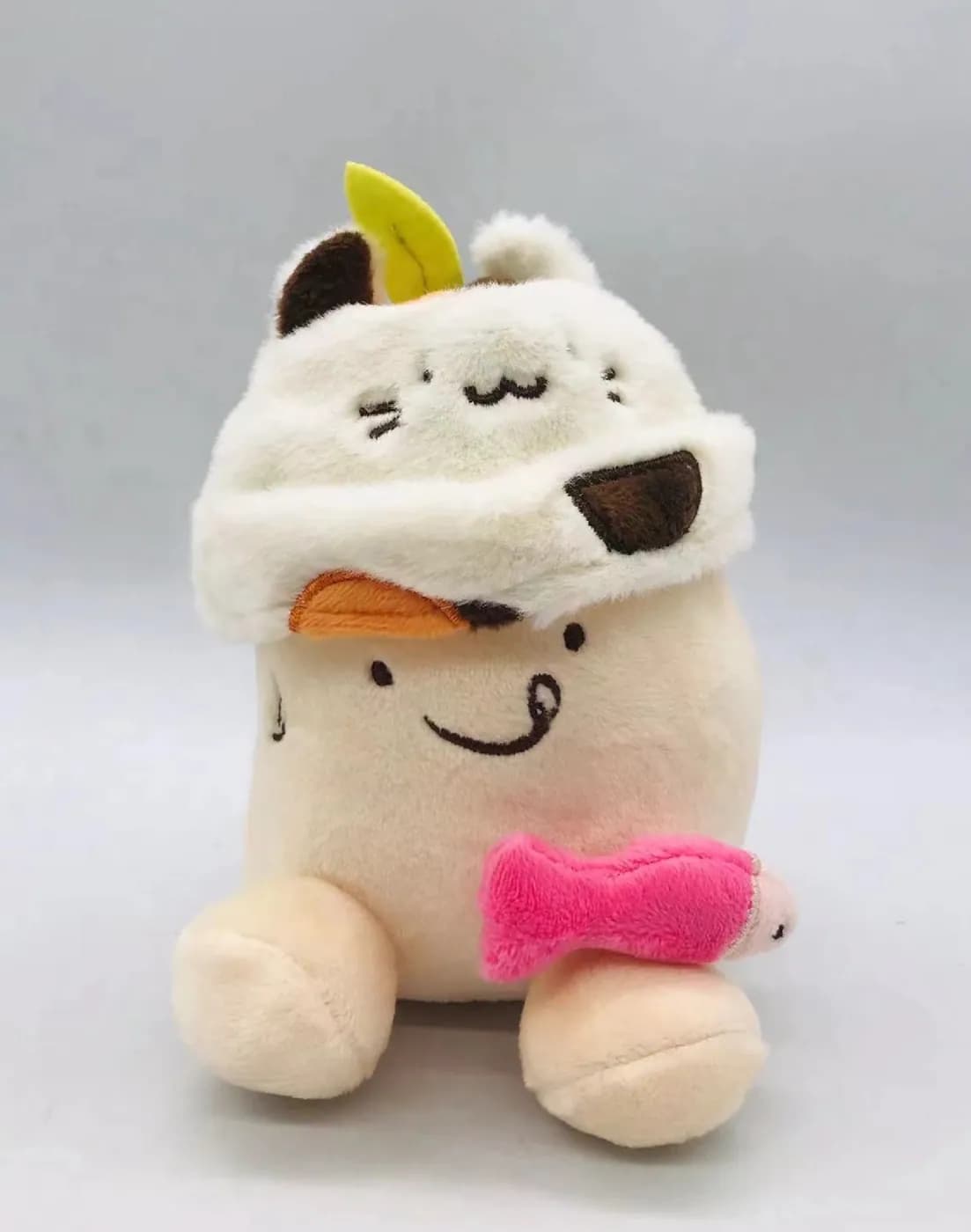 Character plush in a removable cow-print hood