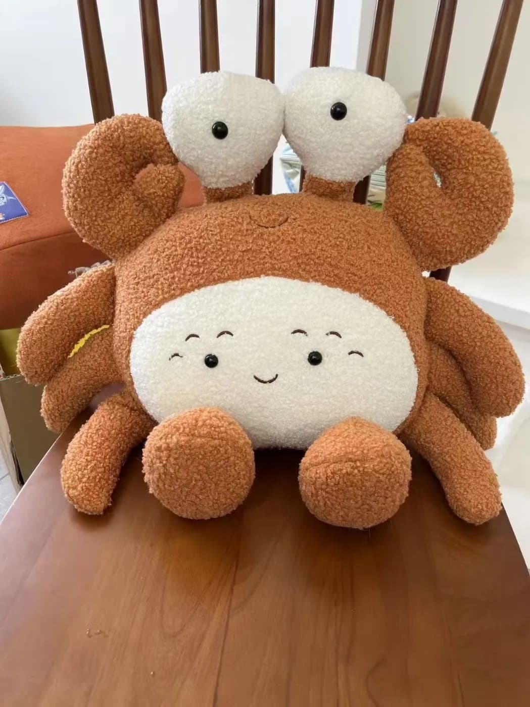 Crab character plush toy with padded claws and an embroidered smile