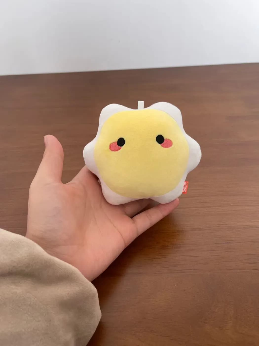 Small yellow flower plush charm with an embroidered face