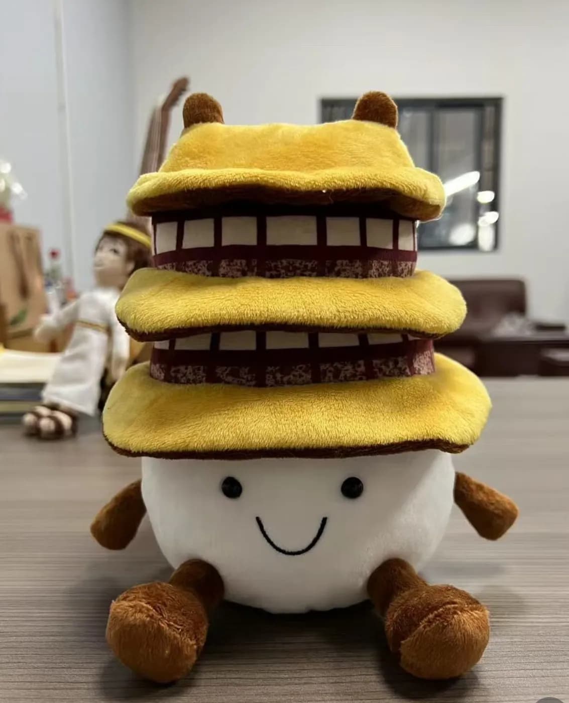 Custom layered cake character plush with contrast piping between tiers