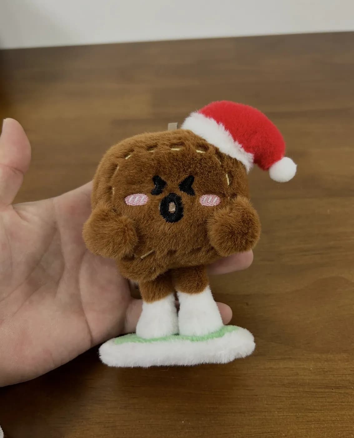 Snack character plush wearing a Santa hat for a holiday range