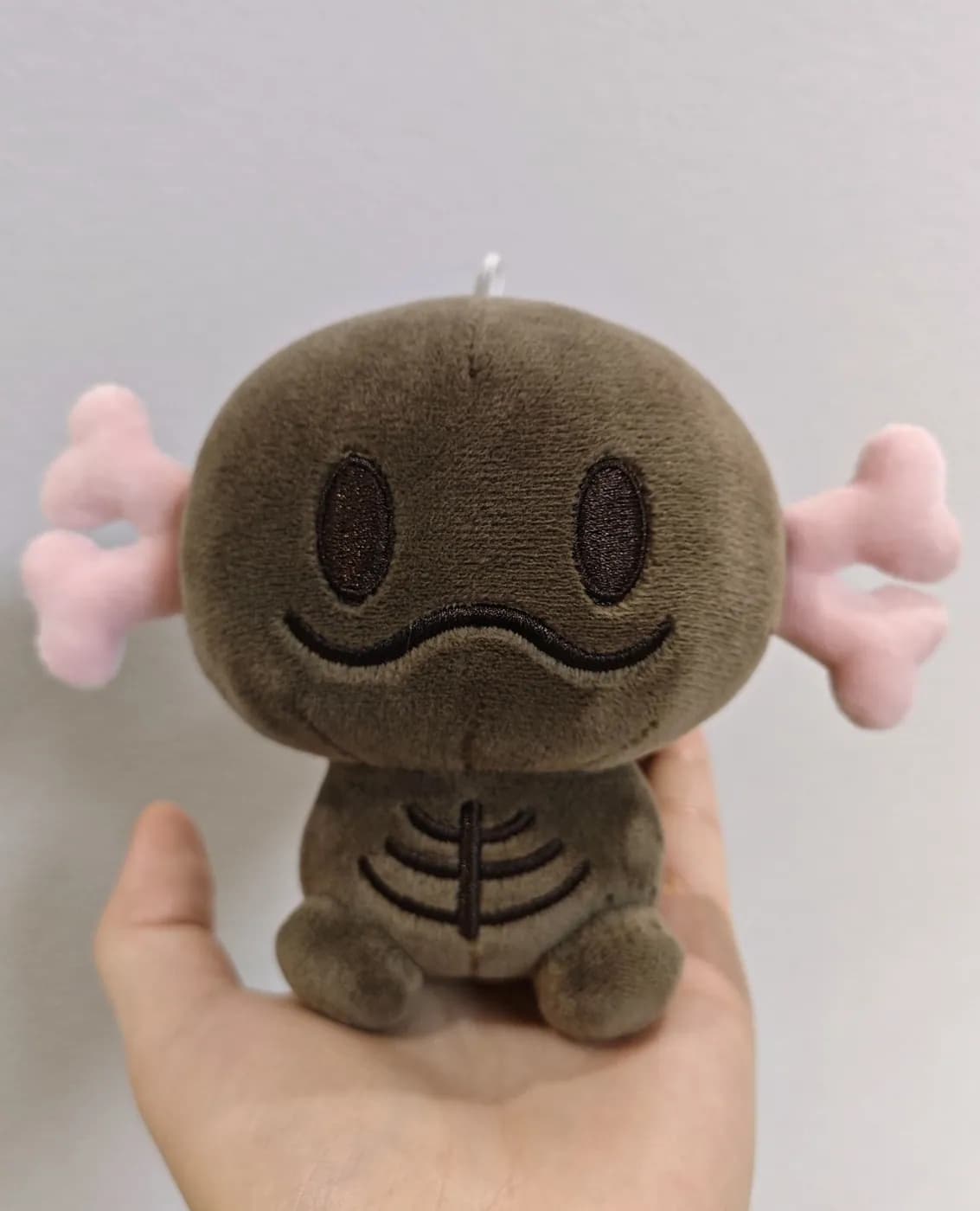 Skeleton character plush with printed bone detail and bone arms