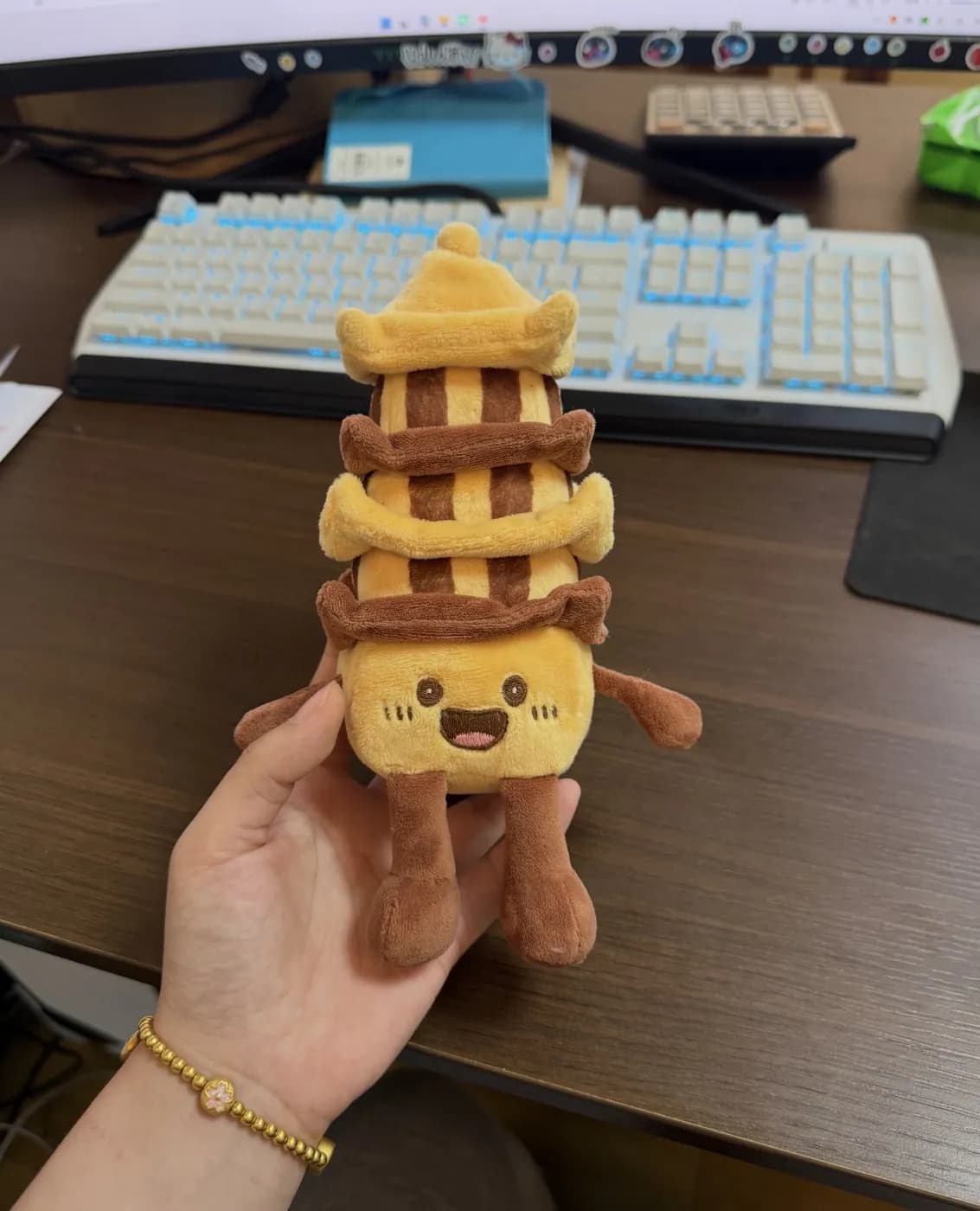Stacked waffle plush charm held in a hand