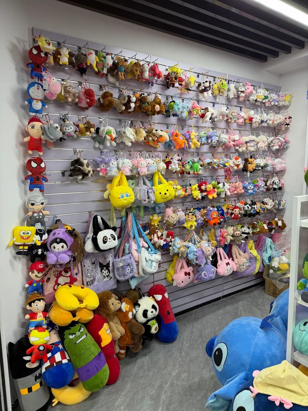 Wall of finished claw machine plush stock in our Shenzhen showroom